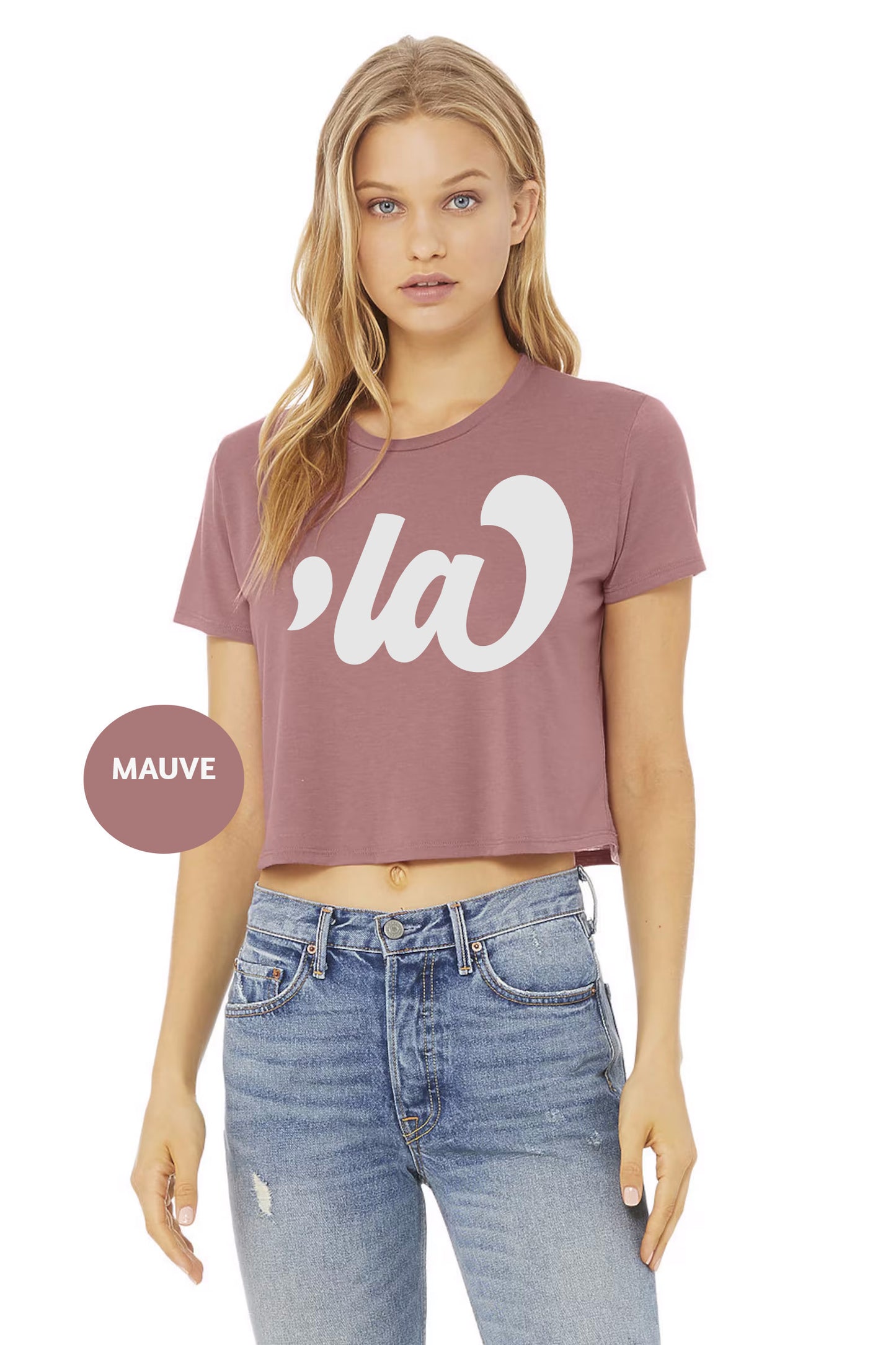 a woman wearing a crop top with the word la on it