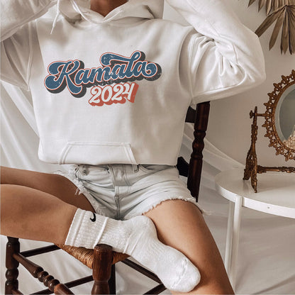 a woman sitting in a chair wearing a kansas sweatshirt