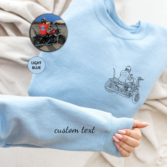 a person wearing a blue sweatshirt with a motorcycle drawn on it
