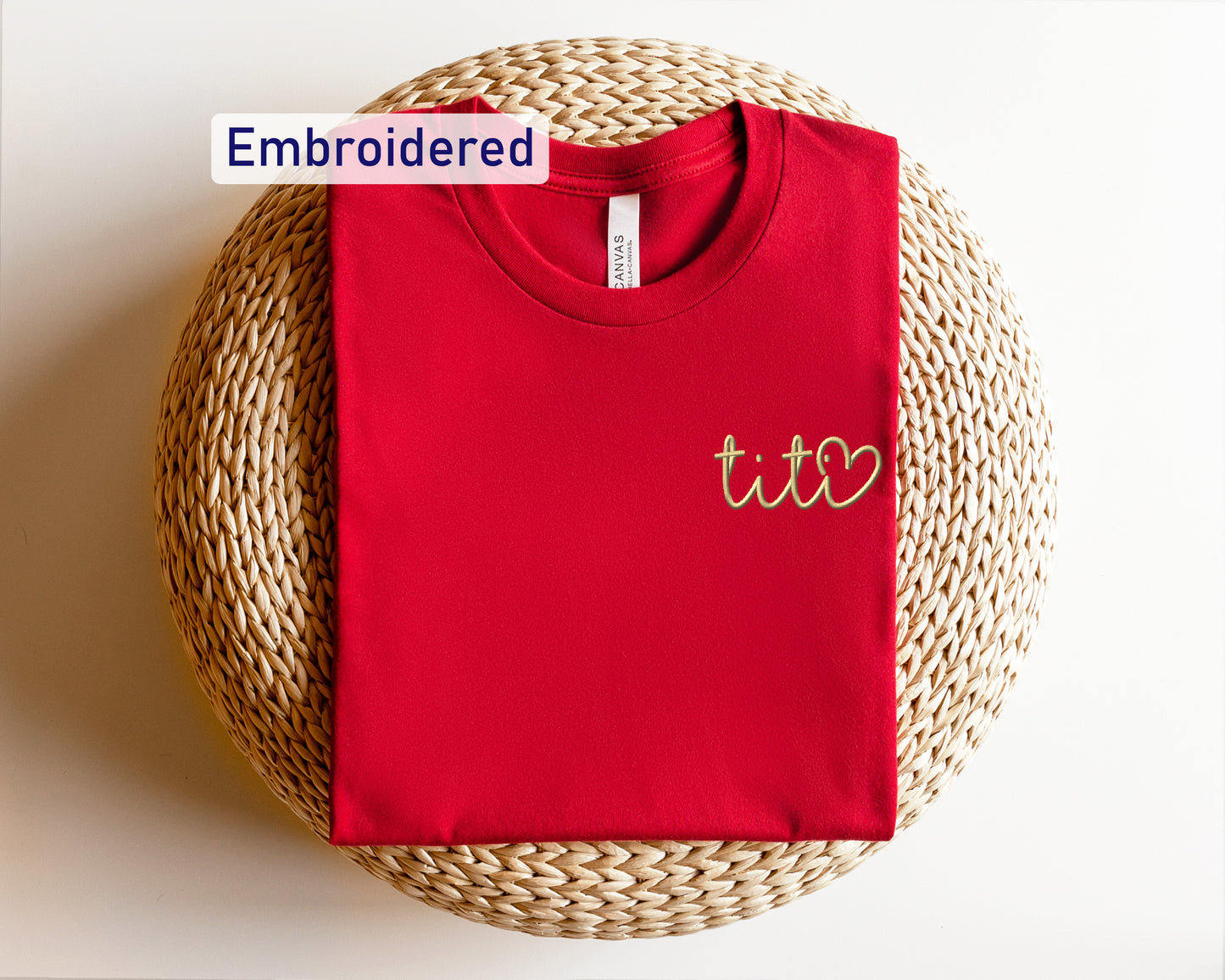 a red t - shirt with the word embroidered on it