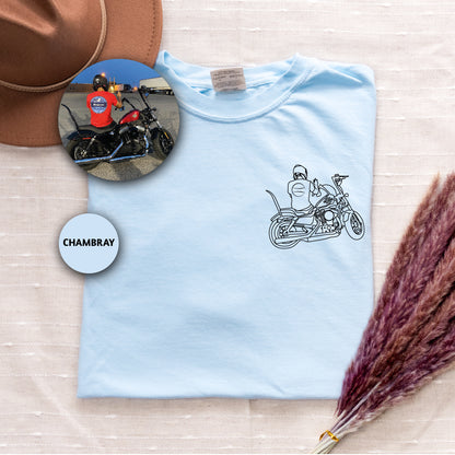 a blue shirt with a picture of a man on a motorcycle