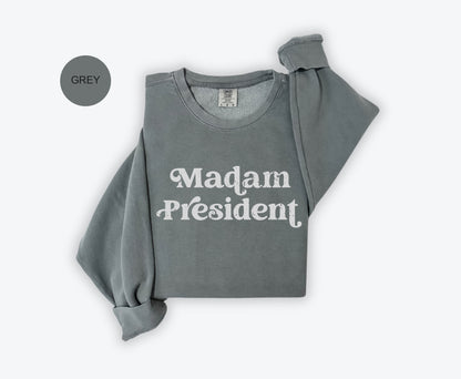 a grey sweatshirt with the words madam president printed on it