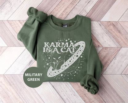 a green sweatshirt with a picture of a cat on it