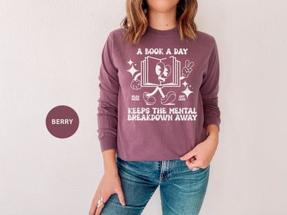 a woman wearing a book a day sweatshirt