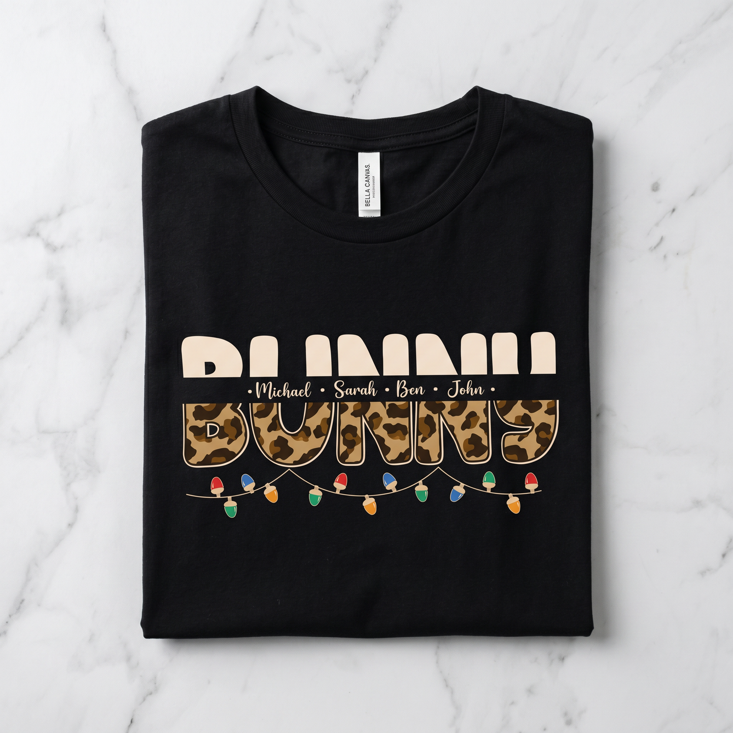 A black t-shirt with a leopard print design and text that says "BUNNY" in a playful font.
