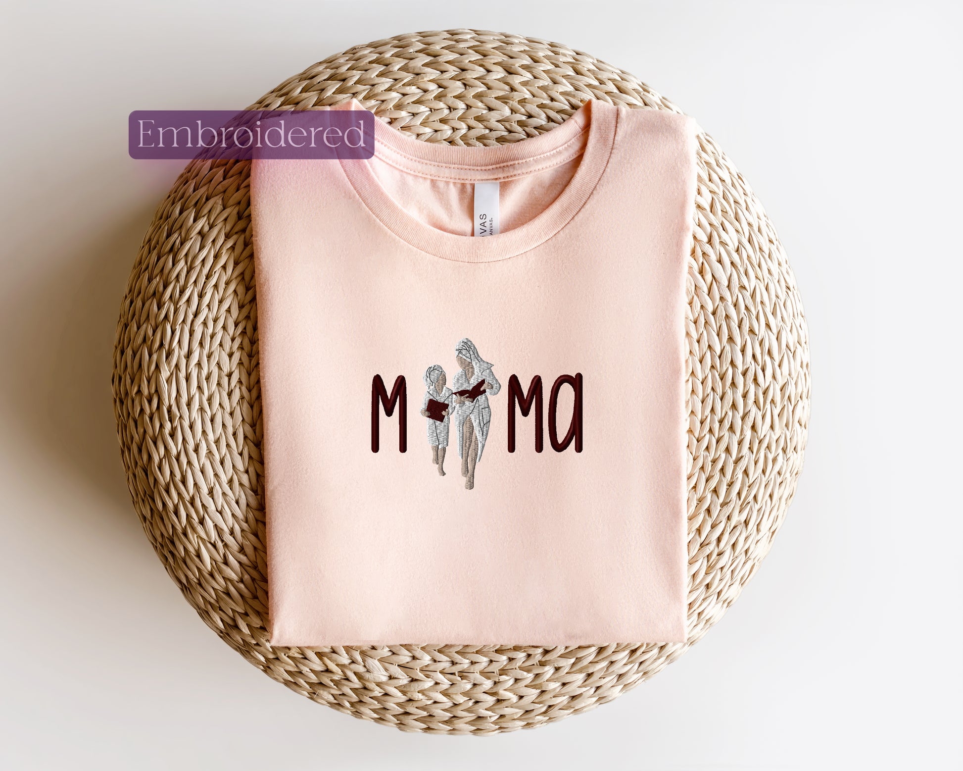 a pink t - shirt with the word mom printed on it