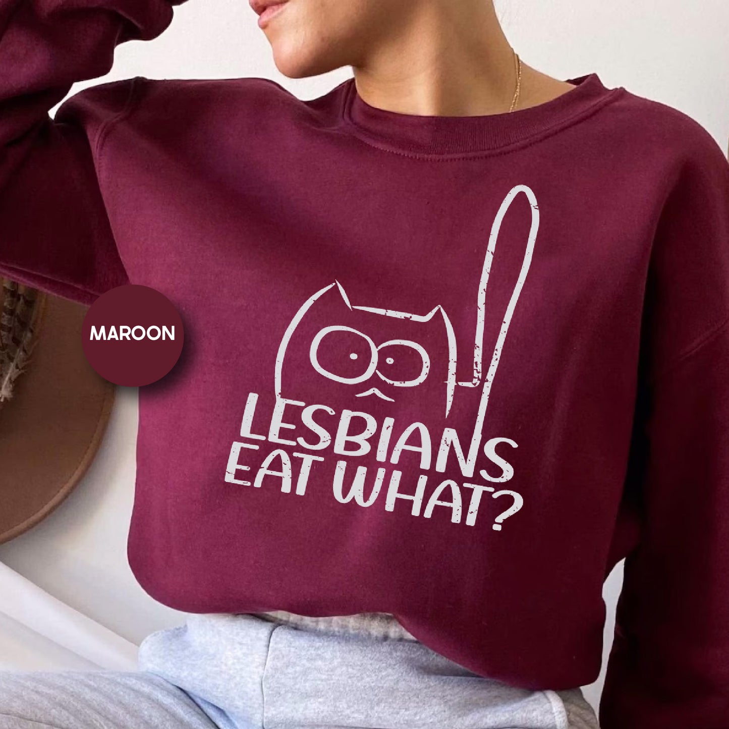 a woman wearing a maroon sweatshirt that says lesbians eat what?