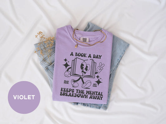 a t - shirt that reads a book a day keeps the mental breakdown away