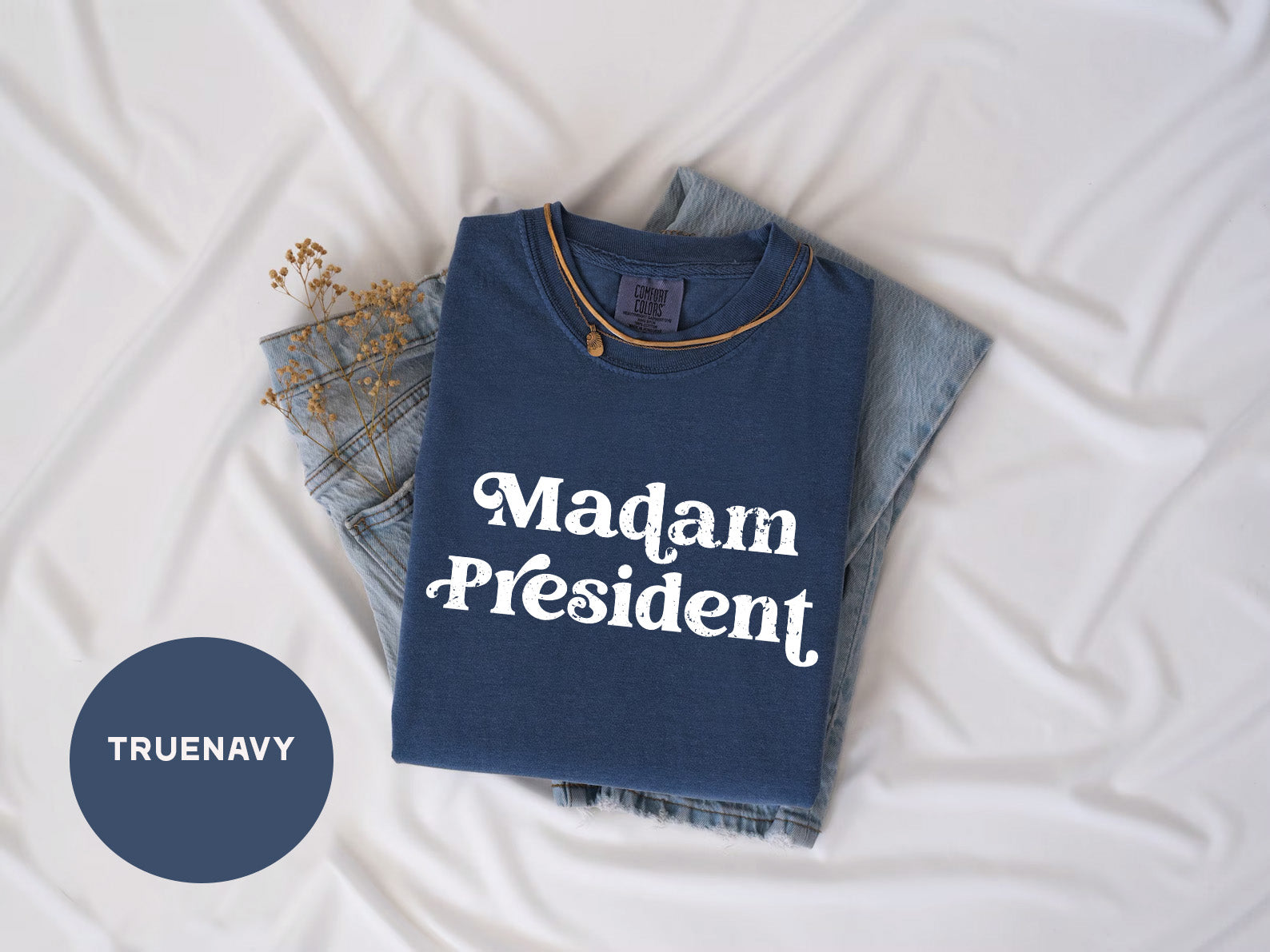 a t - shirt that says madam president next to a pair of jeans