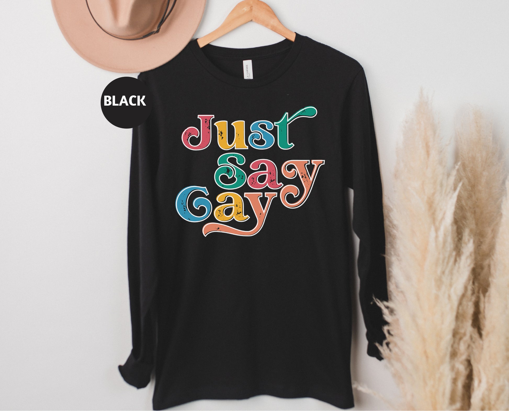 a black t - shirt that says just gay on it