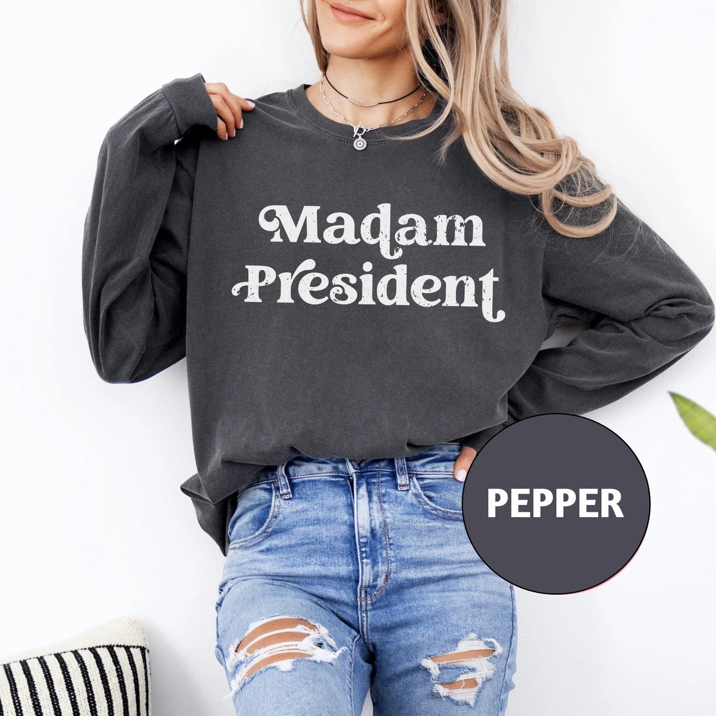 a woman wearing a sweatshirt that says madam president