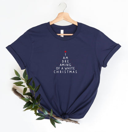 A navy blue t-shirt with white text that says "I AM DREAMING OF A WHITE CHRISTMAS" printed on it.