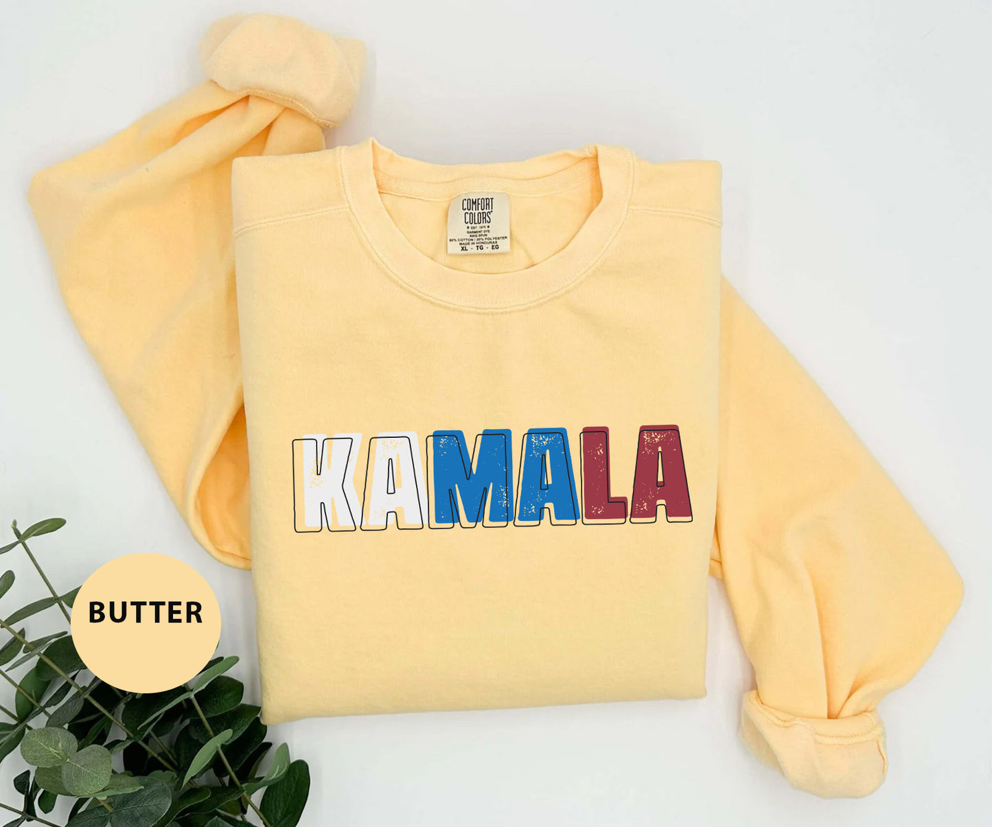 a yellow sweatshirt with the word kaamala printed on it