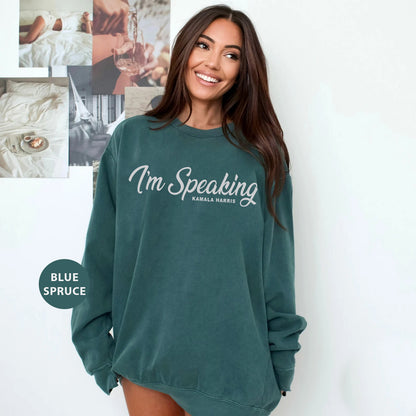 a woman wearing a green sweatshirt with i'm speaking on it