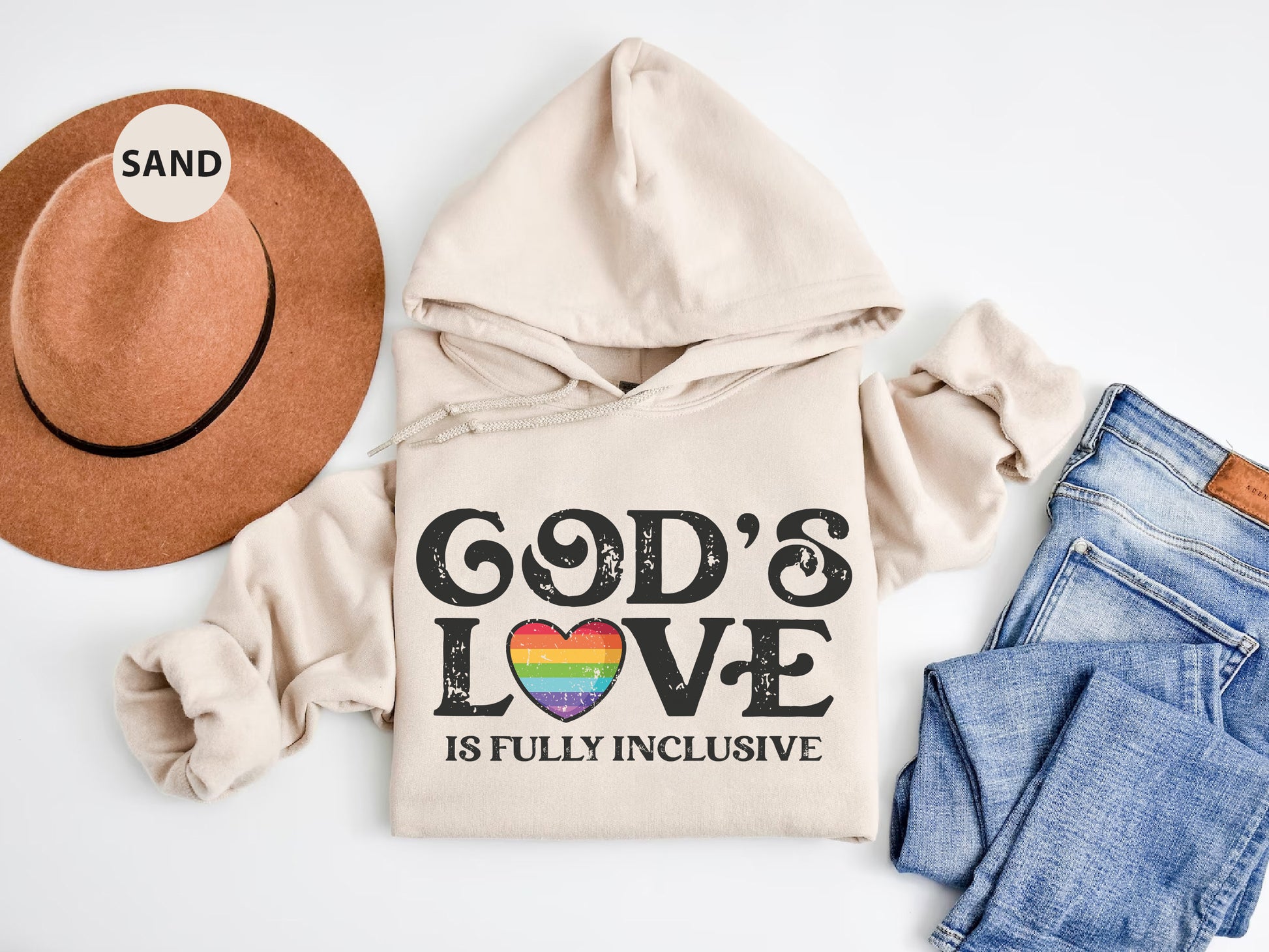 a white hoodie with a rainbow heart and god's love is fully inc