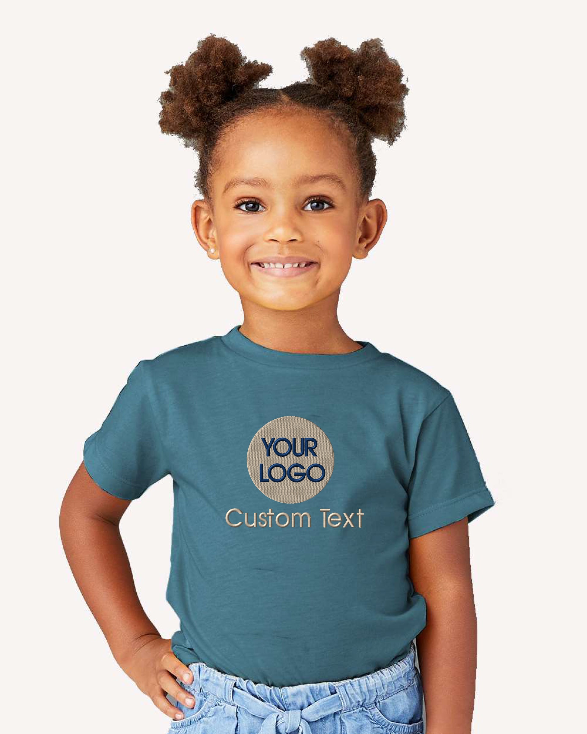 a little girl wearing a t - shirt with a logo on it