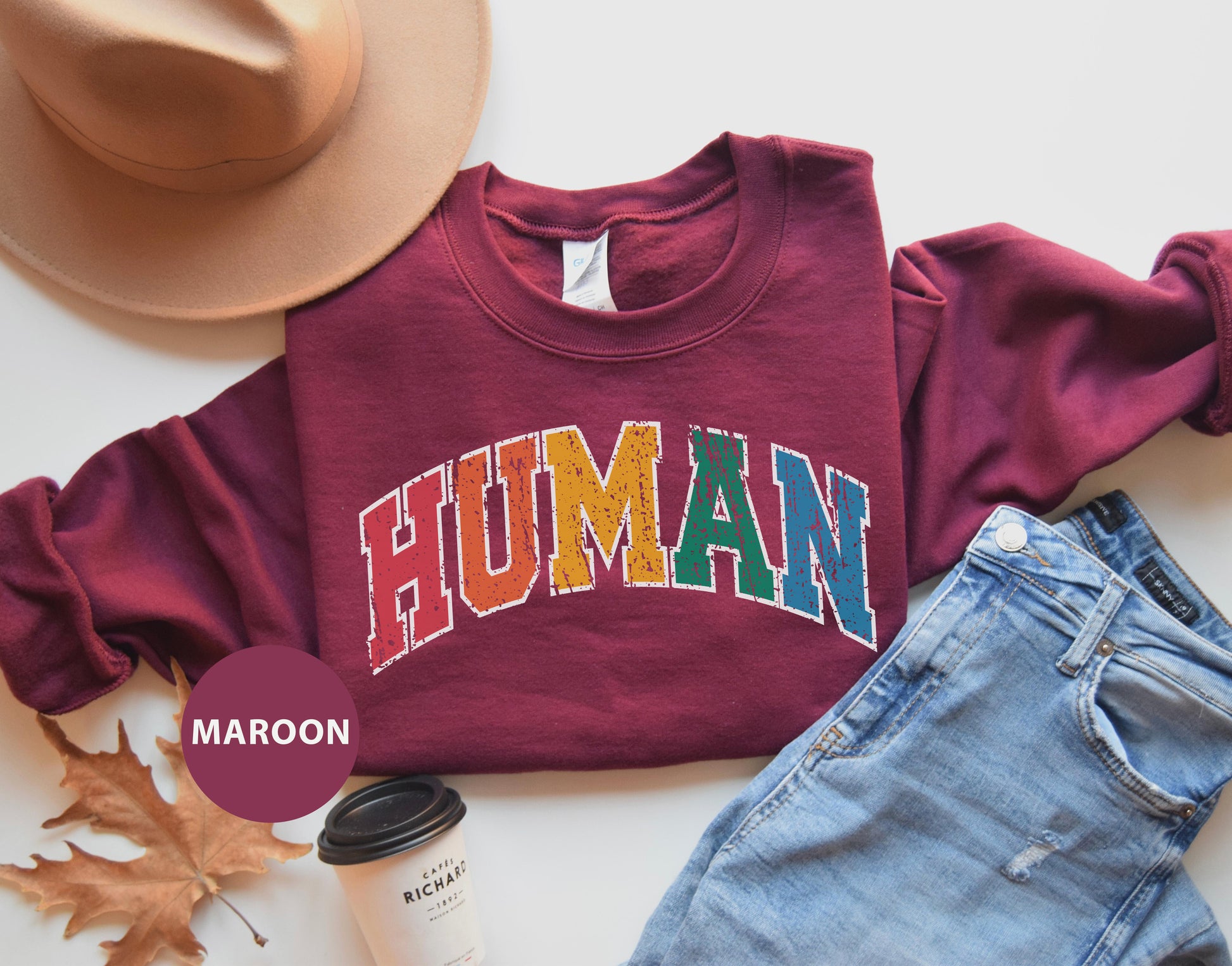 a maroon shirt with the word human on it