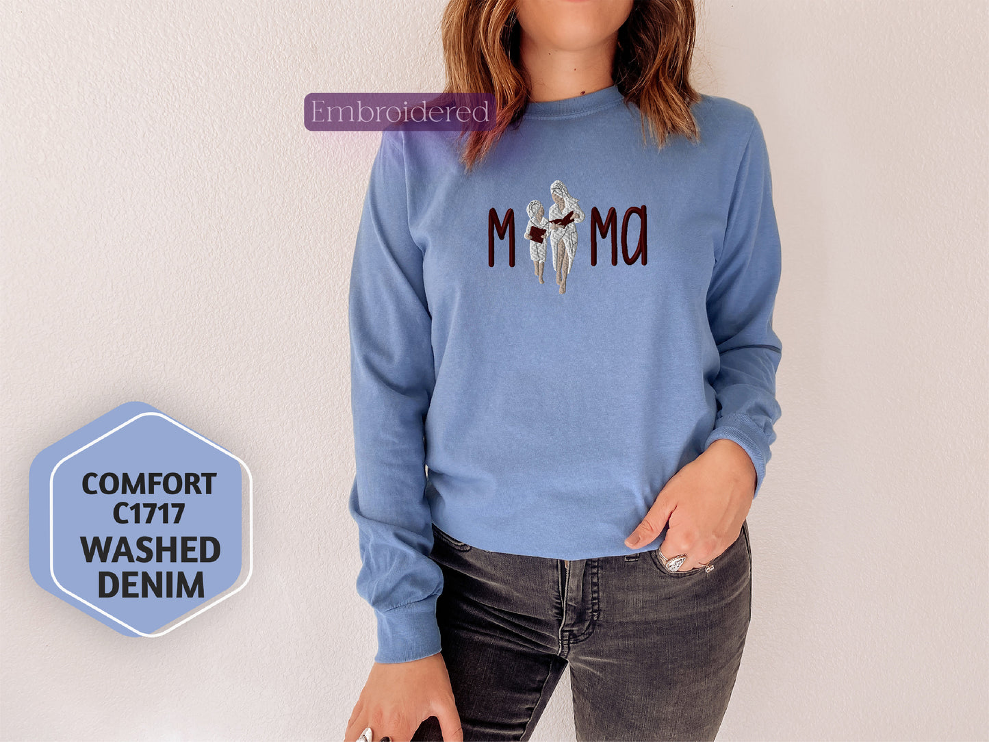 a woman wearing a blue sweatshirt with the word mom printed on it