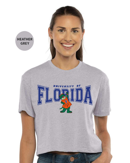 a woman wearing a grey shirt with the university of florida mascot on it