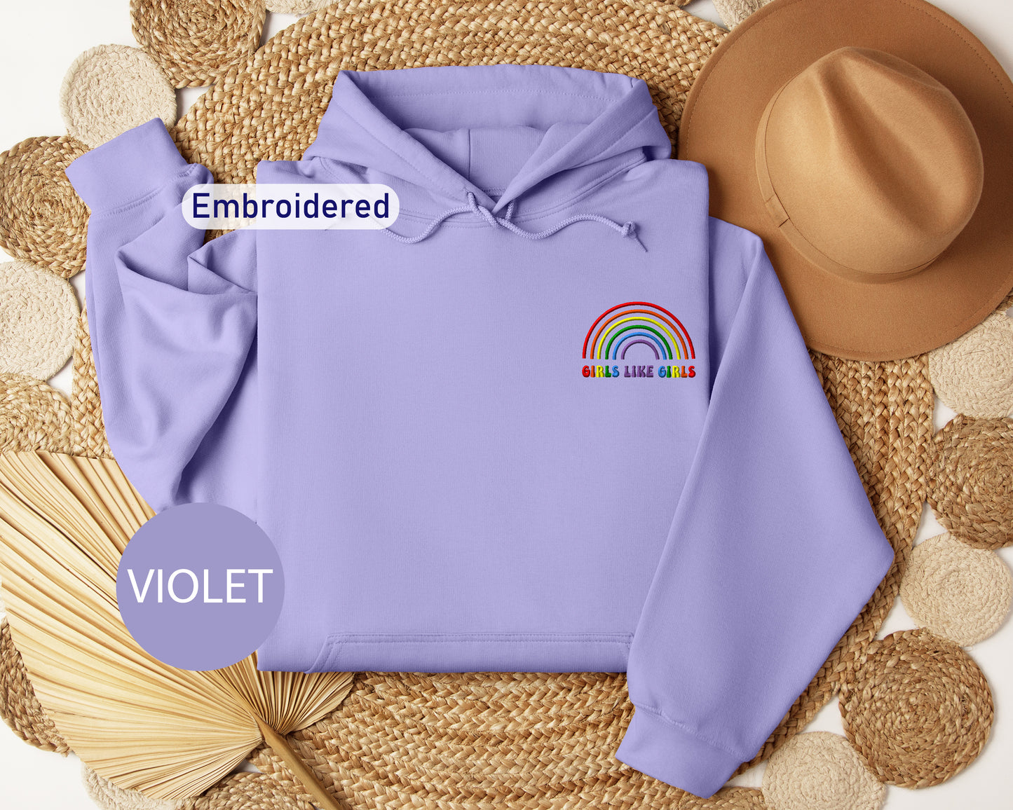 a purple sweatshirt with a rainbow embroidered on it