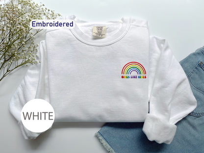 a white shirt with a rainbow embroidered on it