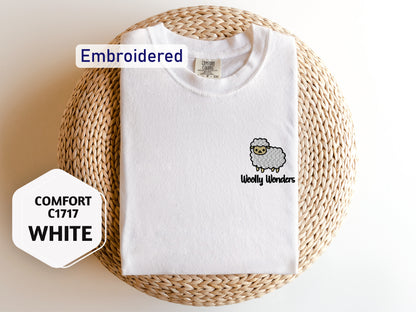 a white t - shirt with a sheep embroidered on it