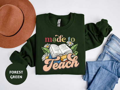 a green shirt that says made to teach next to a hat and jeans