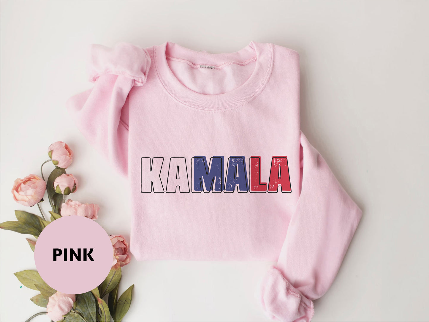 a pink sweater with the word kaamala printed on it