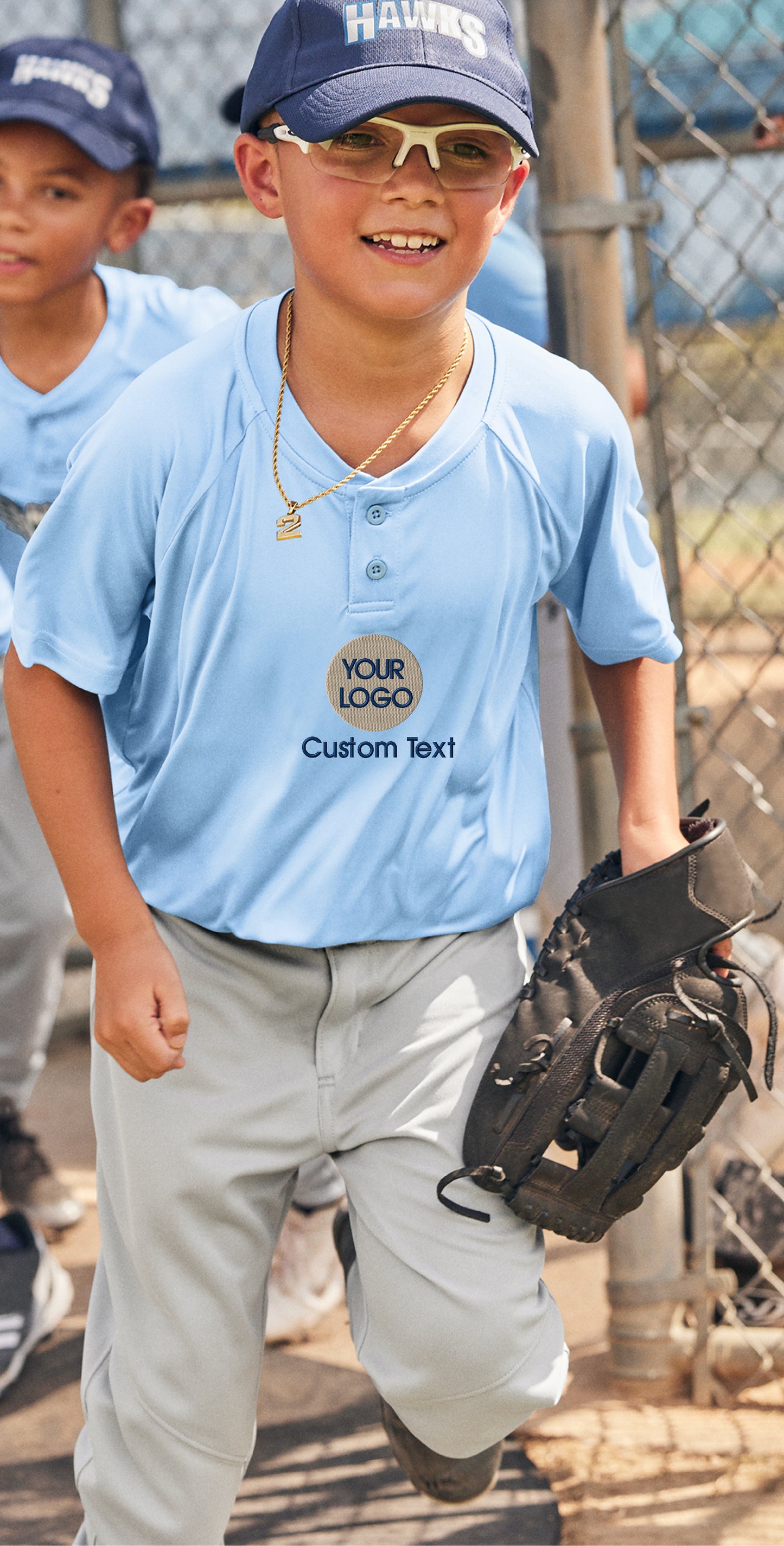 a young boy in a baseball uniform holding a catchers mitt