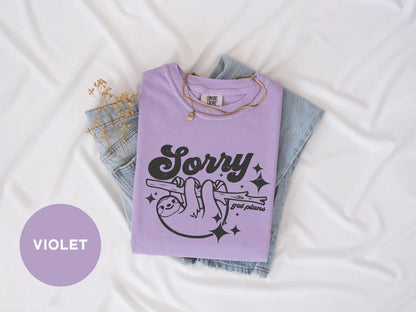 a purple shirt that says sorry on it