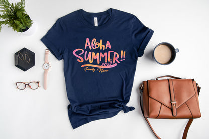 A casual summer outfit consisting of a navy blue t-shirt with a colorful graphic, a brown purse, a pair of glasses, a watch, and a cup of coffee.