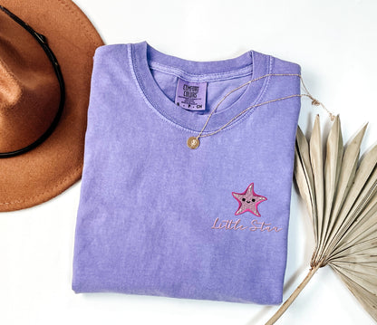 a purple shirt with a star embroidered on it