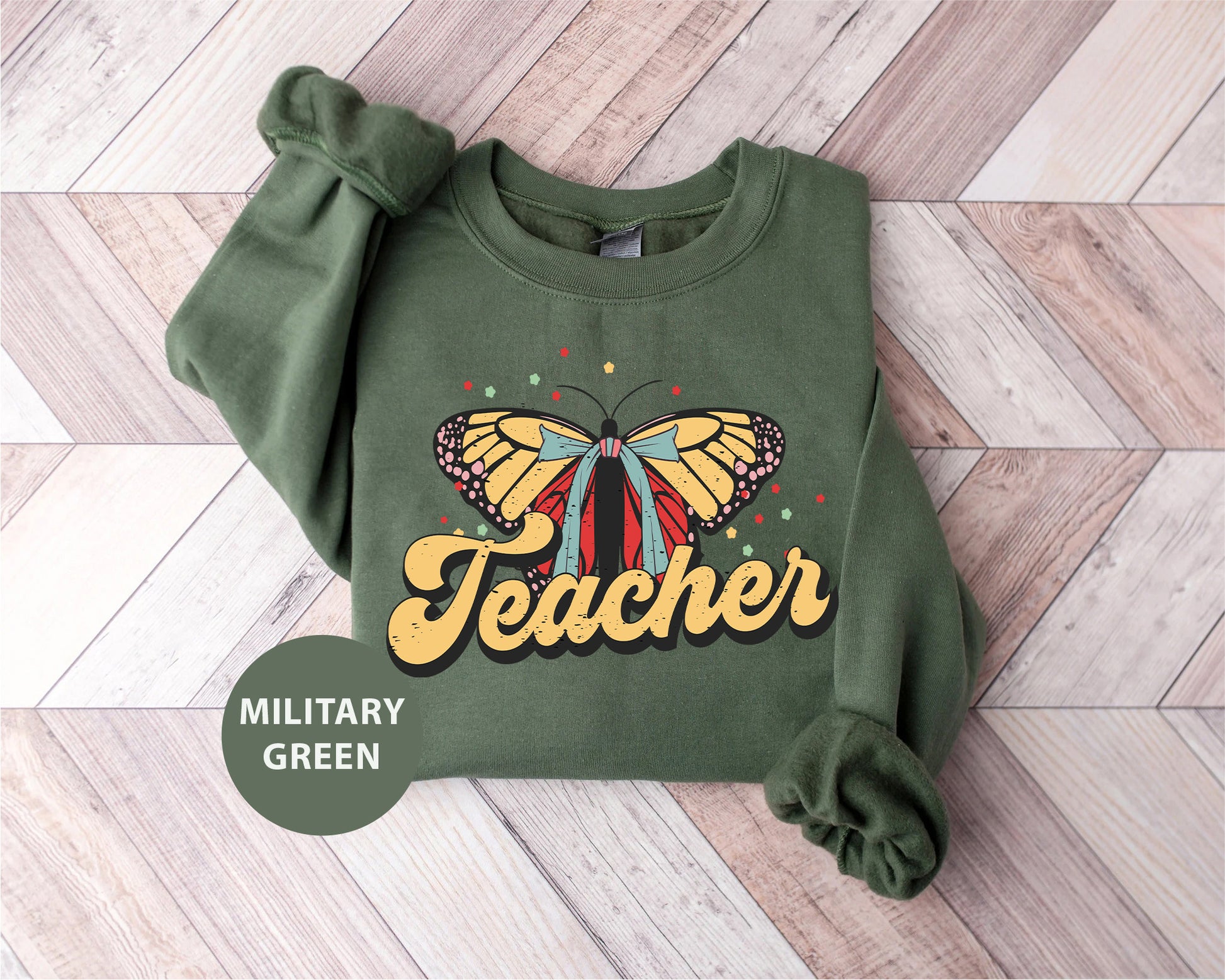 a green sweatshirt with a yellow butterfly on it