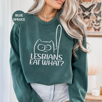 a woman wearing a green sweatshirt that says lesbians eat what?