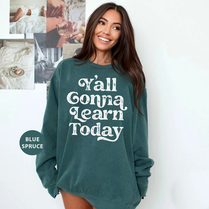 a woman wearing a green sweatshirt that says y'all going learn today