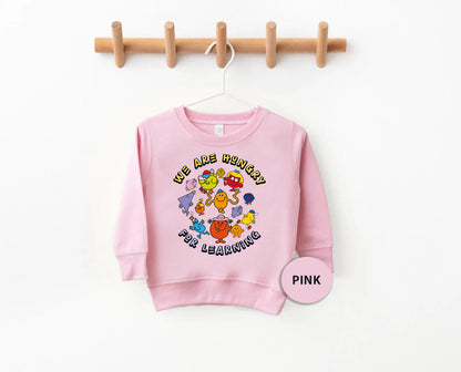 a pink sweatshirt hanging on a clothes line