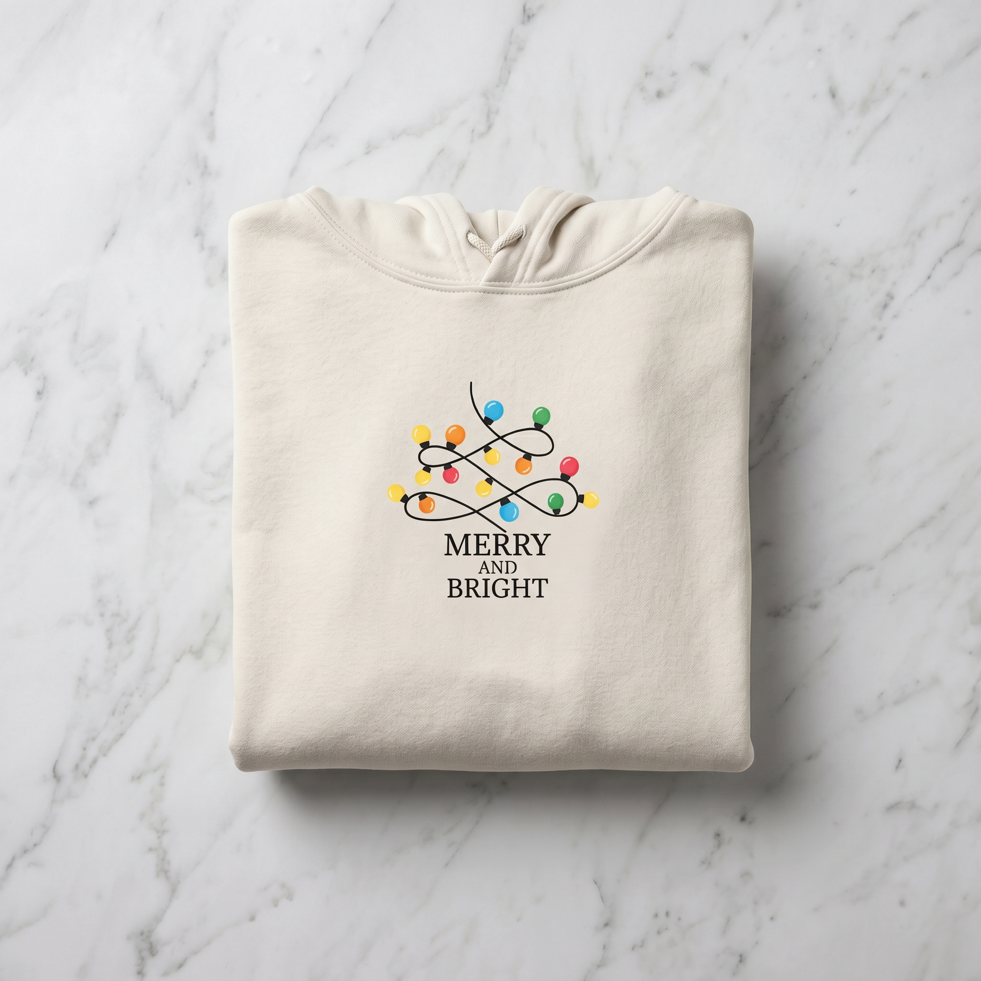 A beige hoodie with a graphic design of colorful Christmas lights and the text "MERRY AND BRIGHT" printed on it.