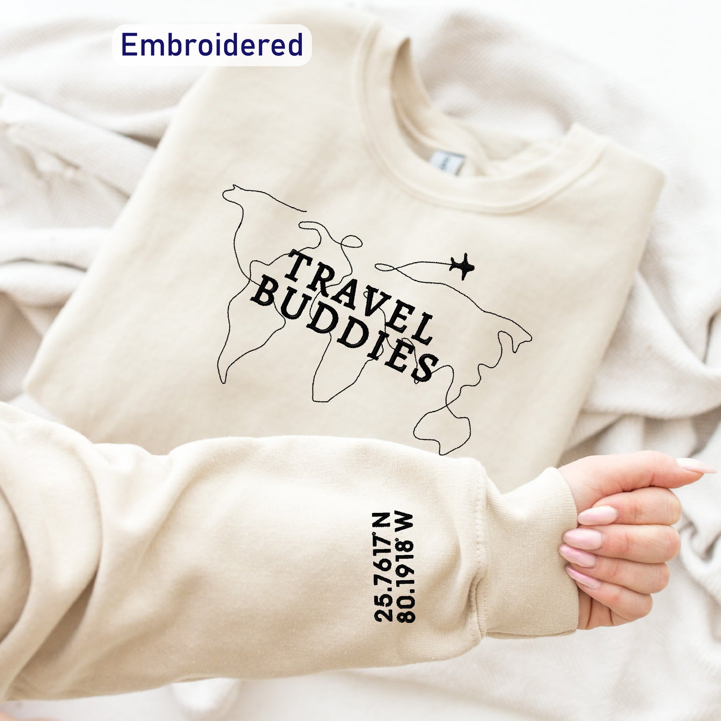 a person holding a t - shirt with the words travel buddies on it