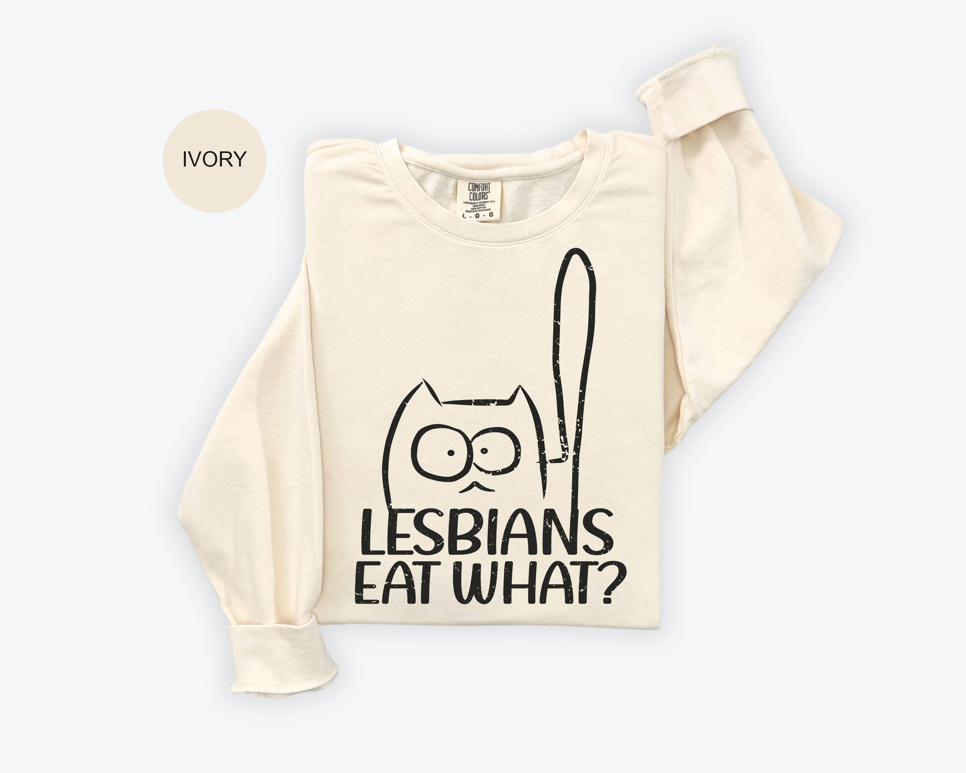 a white t - shirt with a black cat on it that says lesbians eat