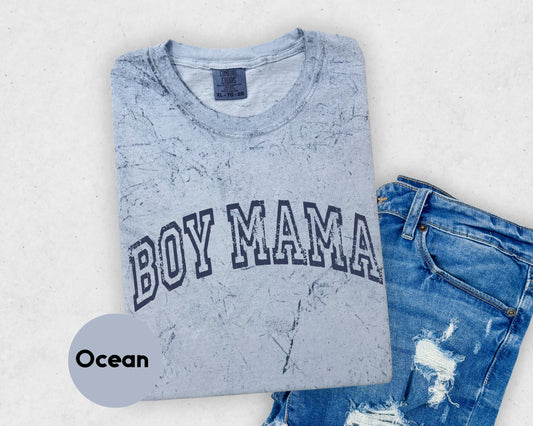 a t - shirt that says boy mama on it next to a pair of ripped