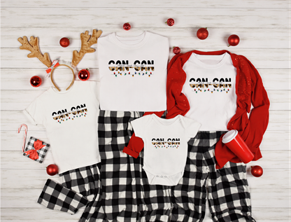 A collection of Christmas-themed items, including t-shirts, pajamas, and ornaments, arranged on a white wooden background.