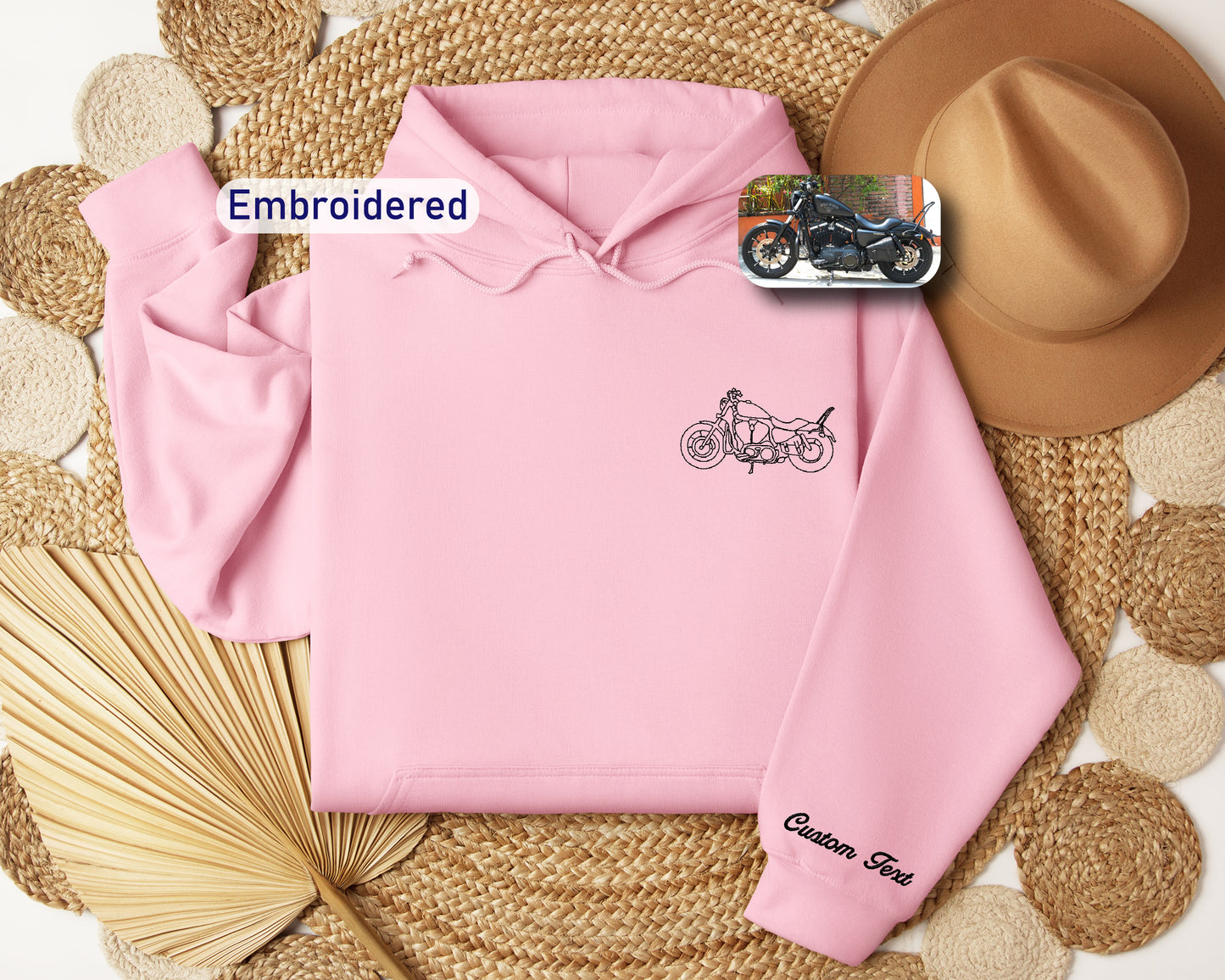 a pink hoodie with a picture of a motorcycle on it