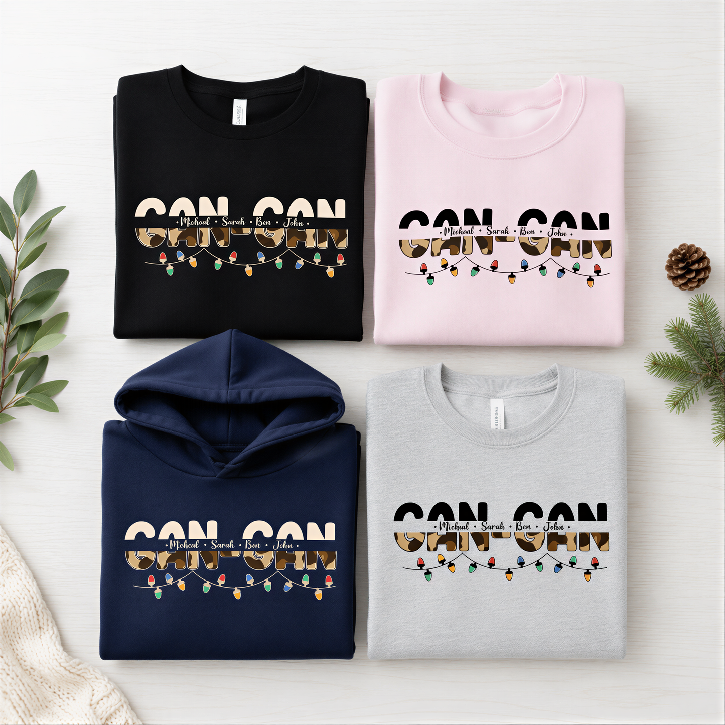 four t-shirts with the text "CAN CON" printed on them, along with a hoodie and a gray sweatshirt. The t-shirts are arranged in a grid-like pattern on a white background, with a pine branch and greenery visible in the top right corner.