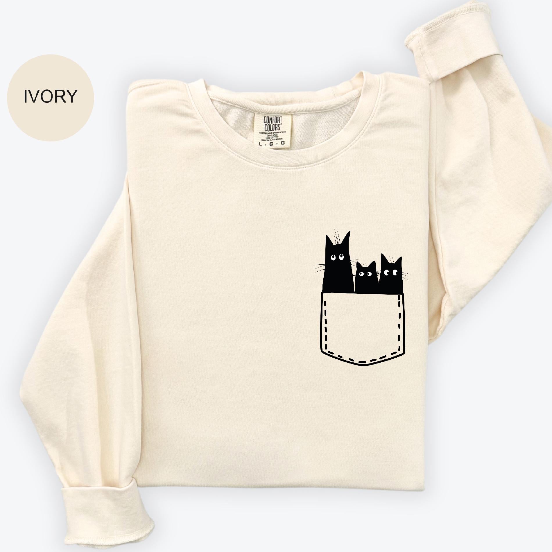 a t - shirt with three cats in a pocket