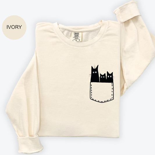 a t - shirt with three cats in a pocket