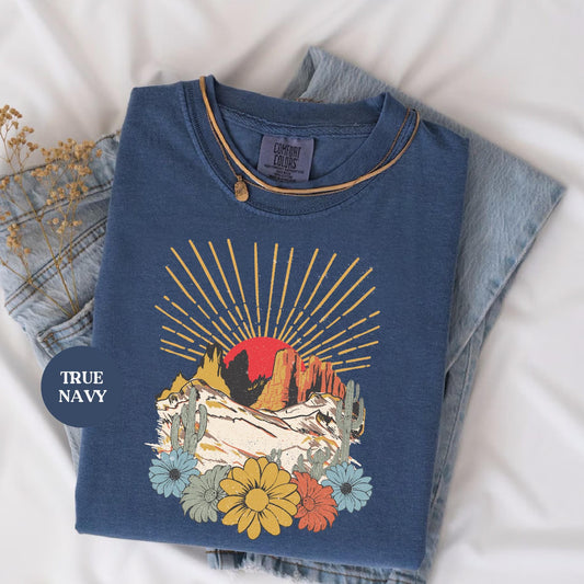 a blue t - shirt with a picture of a mountain on it