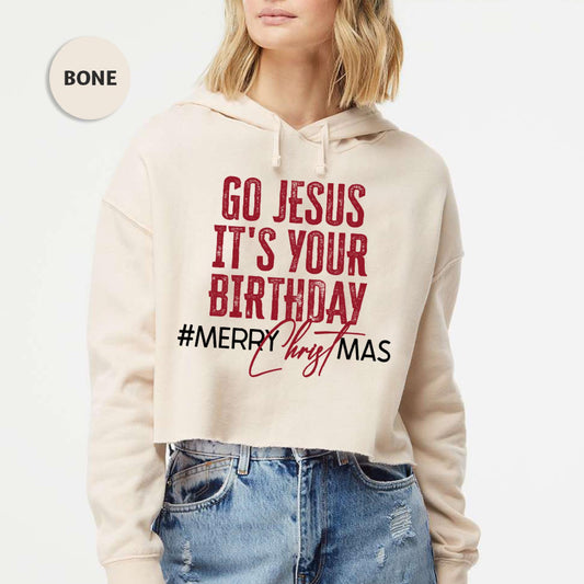 a woman wearing a sweatshirt that says go jesus it's your birthday merry christmas