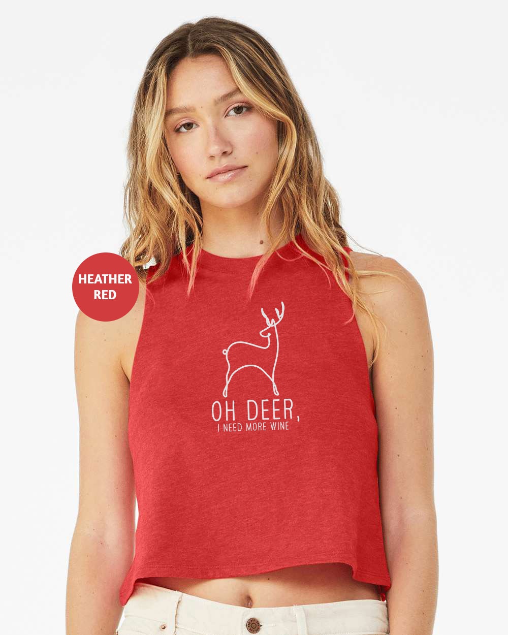 a woman wearing a red crop top with a deer on it