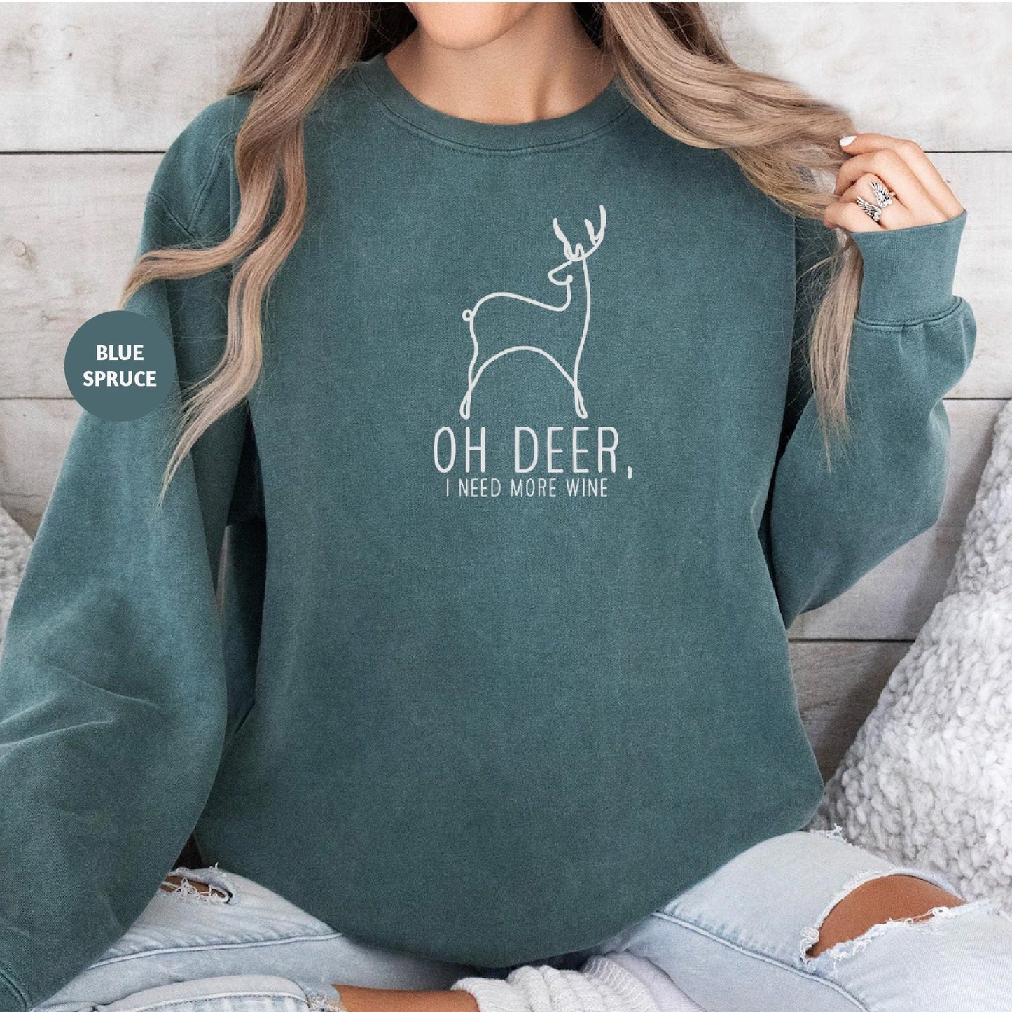 a woman wearing a green sweatshirt with a deer on it