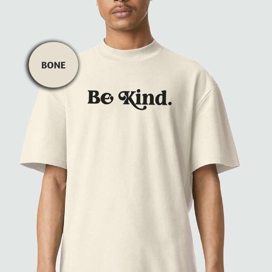a man wearing a white t - shirt with the words be kind printed on it